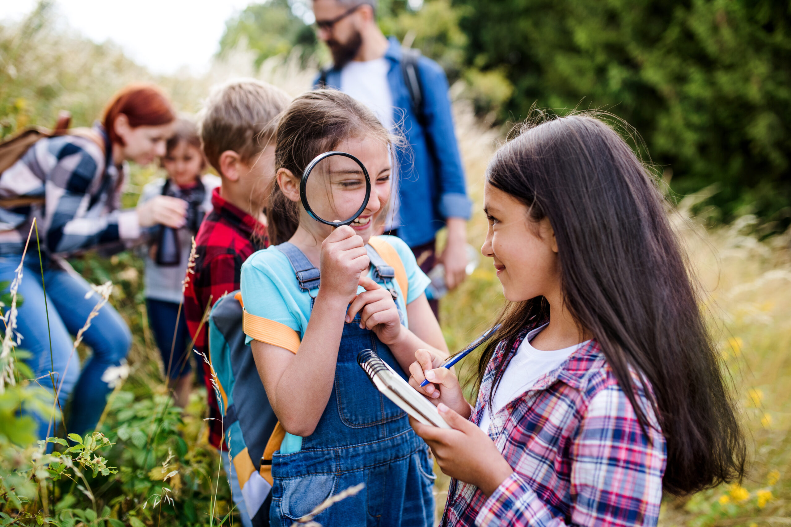 Group of school children with teacher on field trip in nature, learning science. school children,